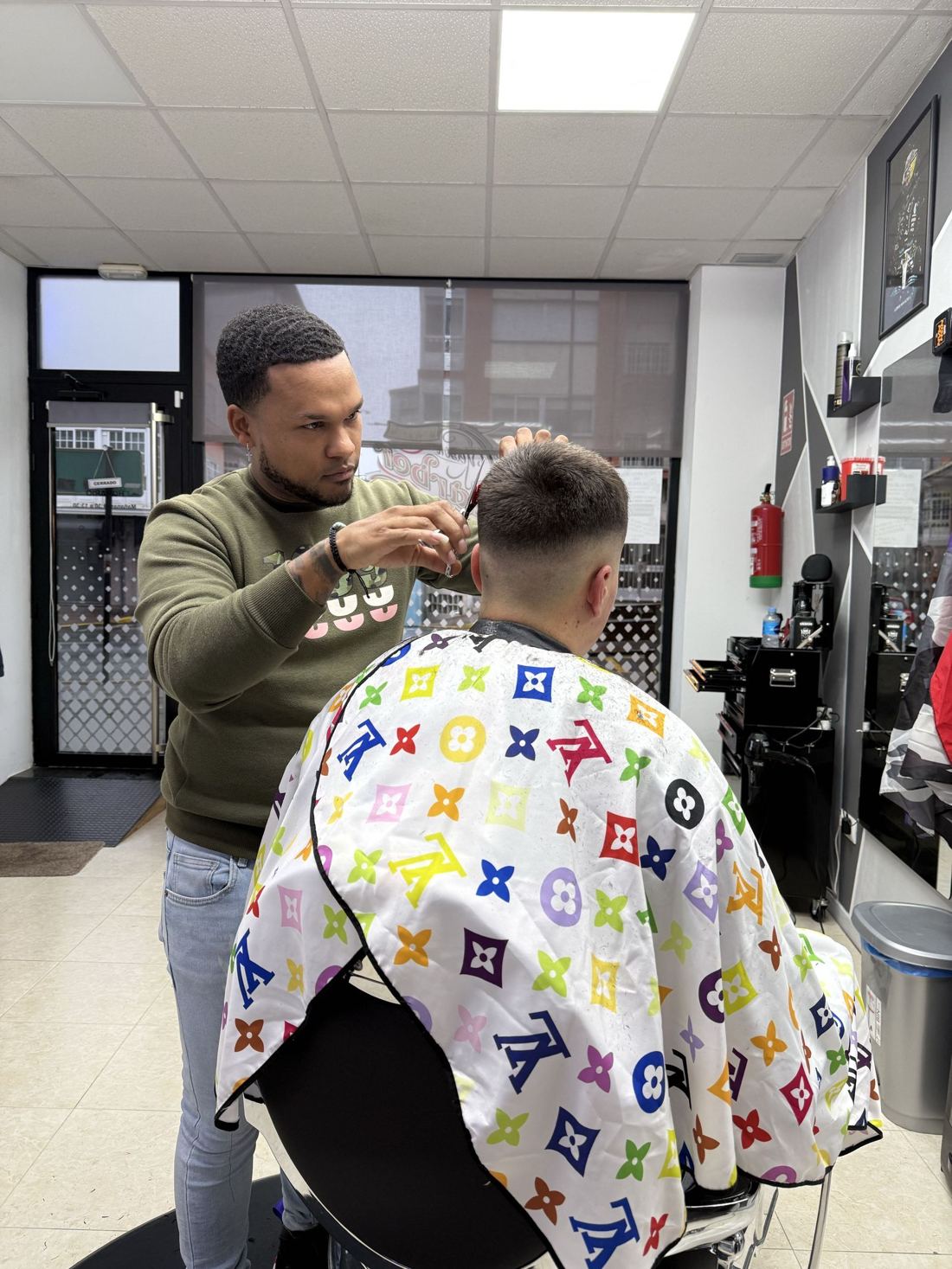 Yeison empezando un corte en la barbería